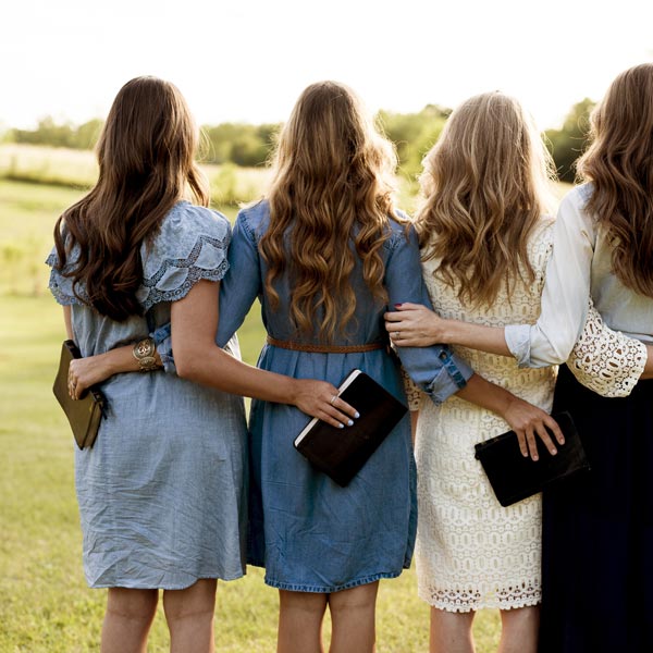 Four Women Hugging with Bibles